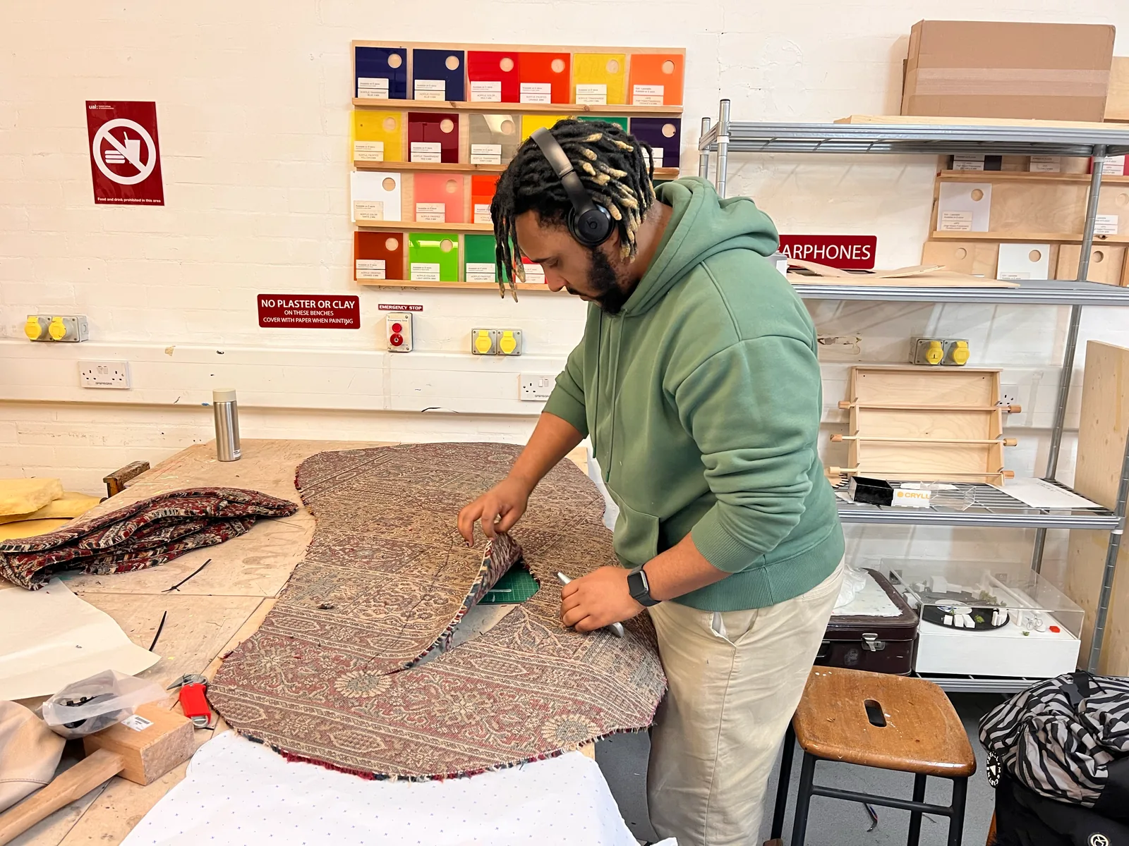 Cutting the carpet’s irregular shape in the workshop.