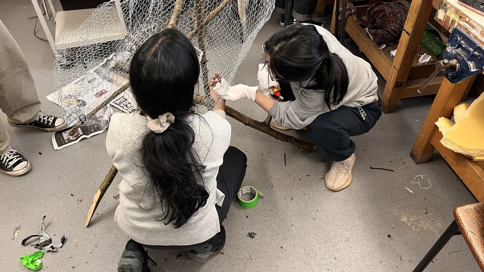 Building the Nest Chair from branches on the studio floor.