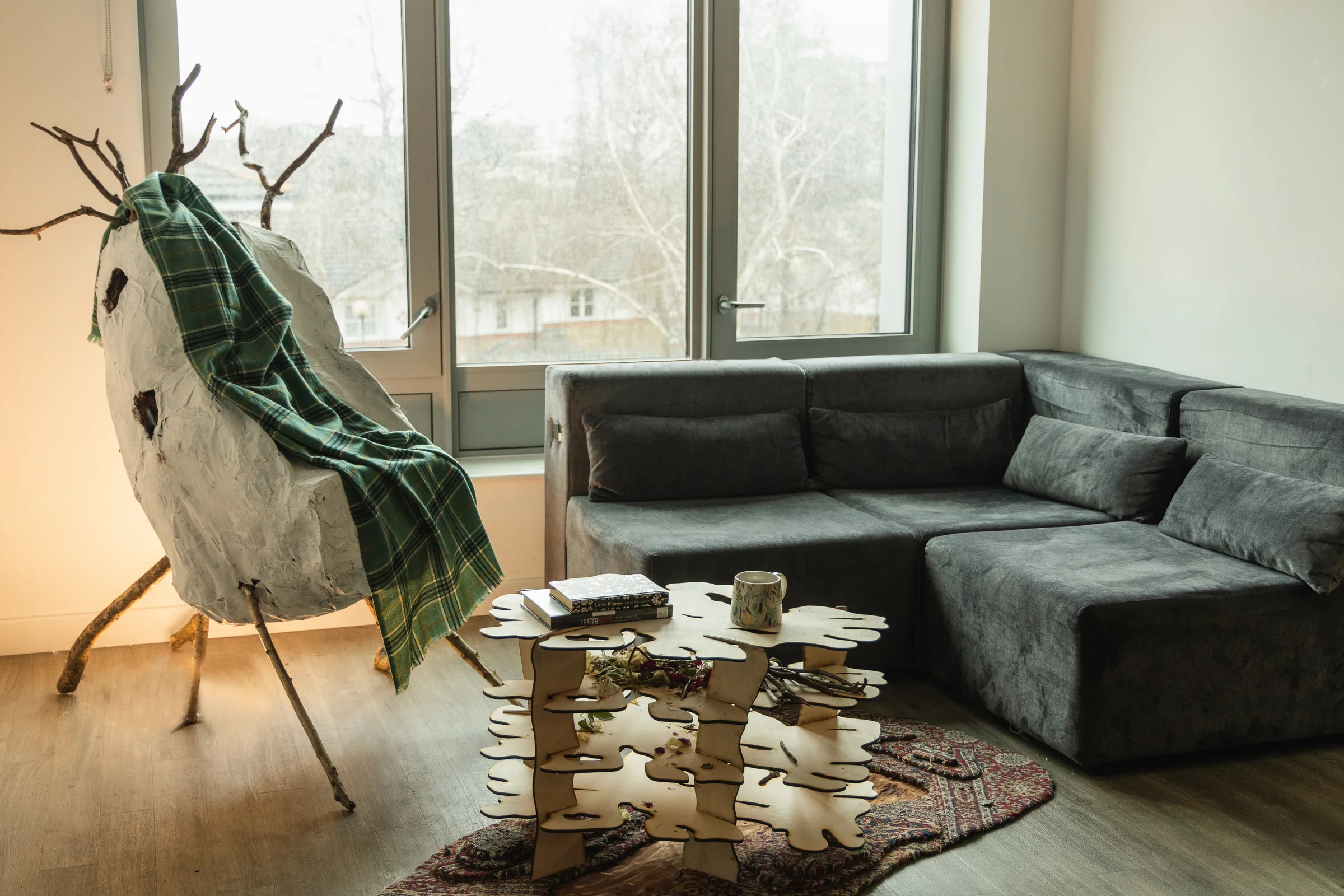 The Little Wood Home room: the Nest Chair and the Creepy Crawly Coffee Table on the Mud Pit Carpet, in a living room.